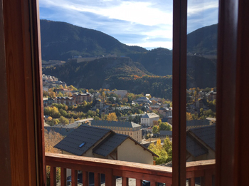 Image of view from window looking over ski resort roofs